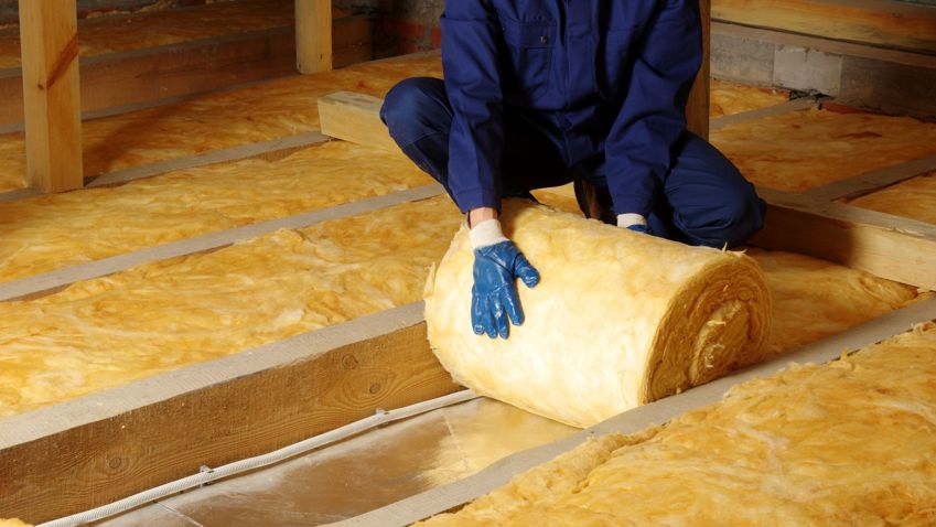 Person laying loft insulation